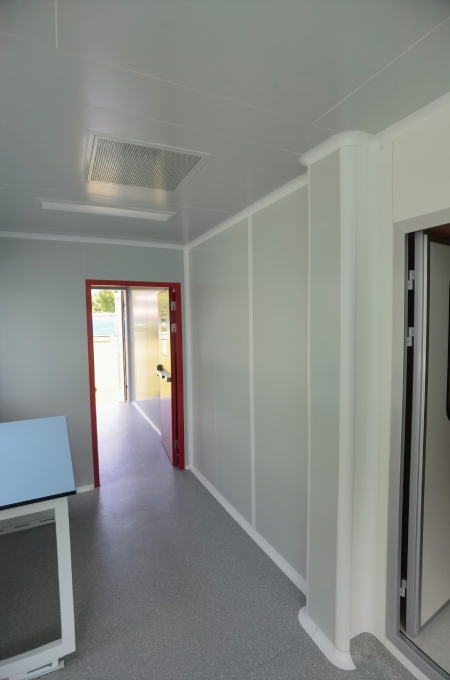 Mechanical service layer inside modular cleanroom with duct insulation and maintenance access