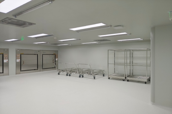 Laboratory animal room interior with cleanroom ceiling panels lighting air outlets and stainless steel transfer carts
